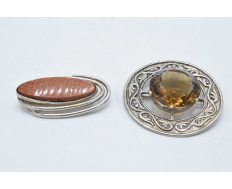 Silver Celtic citrine-style brooch together with a silver galastone brooch (2).  