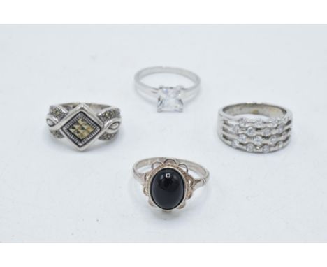 A collection of 4 silver rings of varying designs (4).  