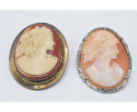 A pair of silver framed cameo brooches, one with marcasites (2).  
