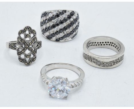 A collection of 4 silver rings of varying designs (4).  