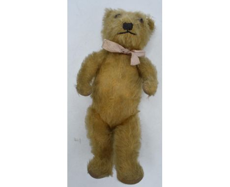 Vintage mid 20th century teddy bear with articulated joints and glass eyes, 31cm tall.  Lost some hair.