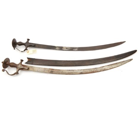 An Indian sword Tulwar, curved blade 30”, iron hilt with knucklebow and disc pommel of traditional form, in its leather cover