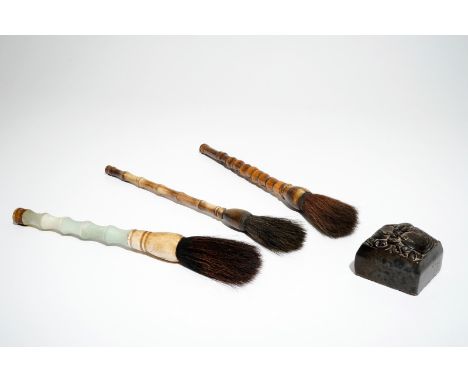 A Chinese stone stamp and three Chinese calligraphy brushes of bamboo, jade and horn, 19/20th C. Dim.: 5,5 x 7 x 7 cm (the se