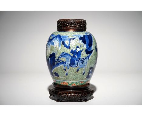 A Chinese famille verte jar with wooden cover and stand, Kangxi H.: 25 cm (incl. cover and stand)H.: 18,5 cm (the vase)   