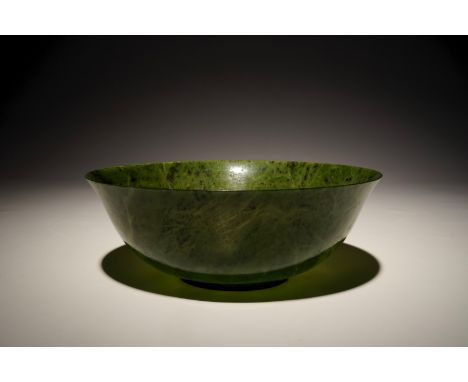 A Chinese thin-walled spinach green jade bowl, 20th C. H.: 8,5 cm - Dia.: 24 cm  Provenance: Acquired in Hong Kong, ca. 1980.