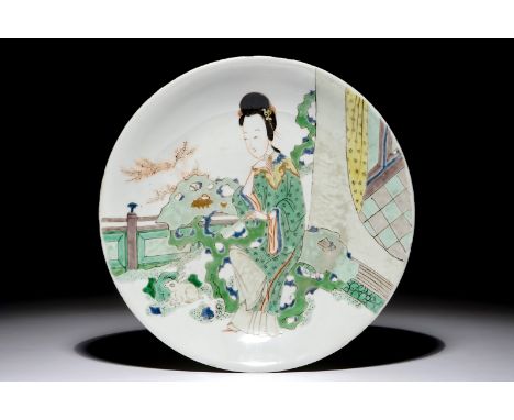 A Chinese famille verte plate with a lady in the garden, Kangxi mark and period Dia.: 27 cm  Provenance: - An exhibition labe
