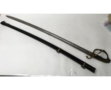 An early 19th century Cavalry saber, with a lions head pommel and scabbard.