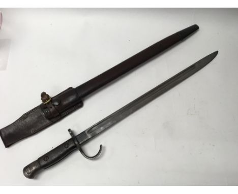 A British WW1 hooked quillian pattern 1907 Bayonet for the SMLE rifle, various markings with frog and scabbard.