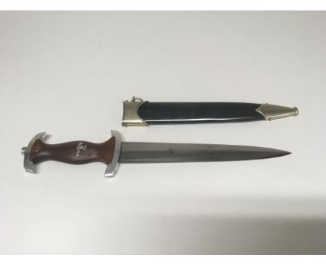 A German WW2 SA dagger with blank blade, stamped MB to the cross guard reverse. Black scabbard.