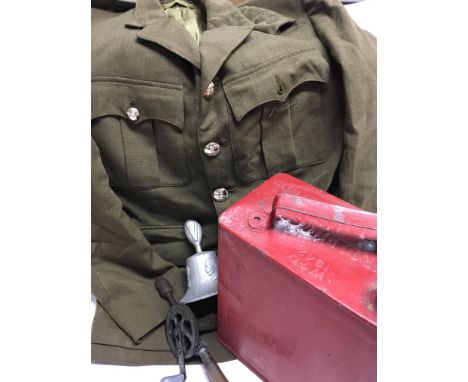 A quantity of military items including Tunic, RAF benevolent fund aluminium bell, 1942 W.D petrol can, 1944 hand drill with a