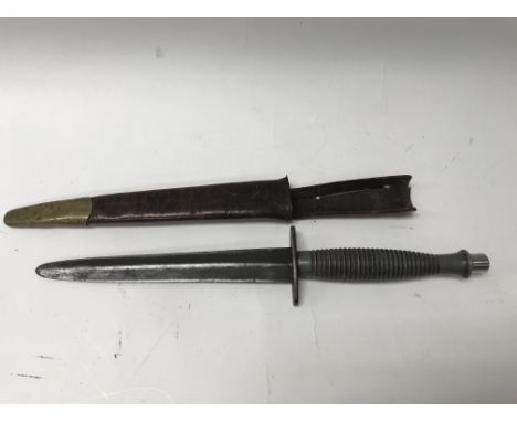 A WW2 3rd path Fairbairn Sykes fighting knife with leather scabbard.