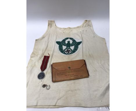 A small collection of military items to include an unusual vest bearing a Swastika and Reichsadler eagle, an army reserve boo