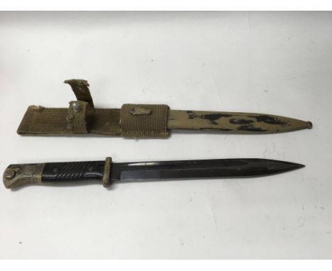 A German WW2 Afrika Korps Kar 98 bayonet, with canvas scabbard frog.