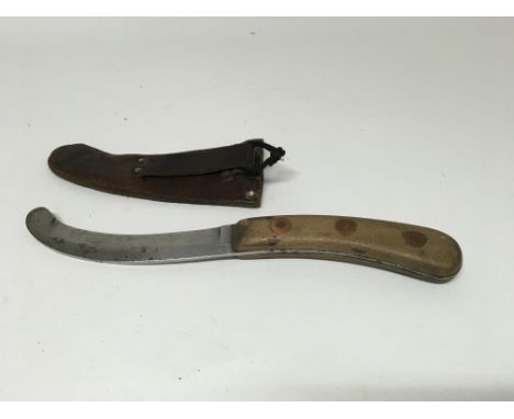 An RAF escape knife with leather scabbard.