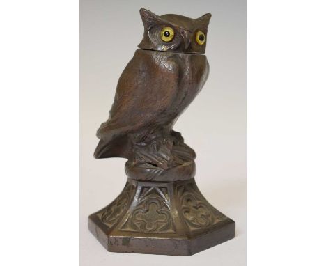 Vintage cast metal owl table lighter, with glass eyes and feather detailing, perched over hexagonal base with quatrefoil deco