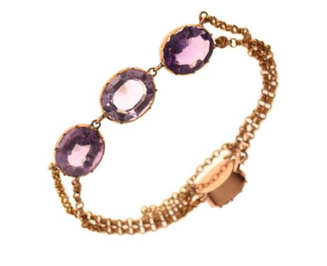Early 20th century amethyst-coloured stone bracelet, the three principal oval stones to a double belcher link chain, the clas