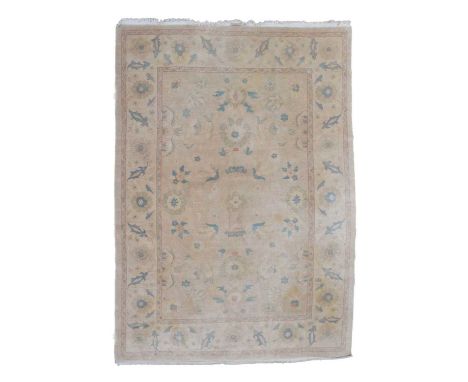 Large Persian design wool rug or carpet, machine made, the sand coloured field having allover floral and foliate decoration, 
