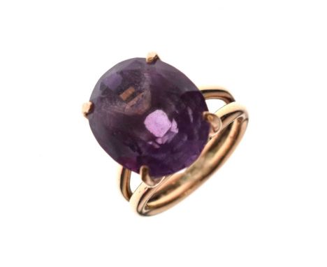 Amethyst yellow metal dress ring, the large faceted oval stone measuring approximately 13mm x 15.5mm 11.5mm deep, the yellow 