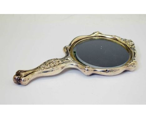 Early 20th century sterling silver backed hand mirror, probably American, the bevelled 11.5cm circular plate within floral su