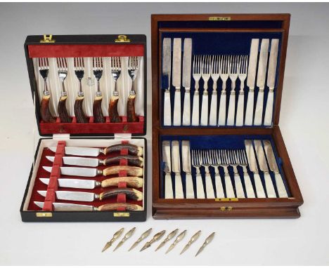 Cased set of horn handle cutlery with Garrad case, cased set of eighteen mother-of-pearl dessert knives and forks, and a set 