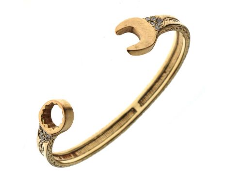 9ct gold diamond set 'spanner' bangle, the torque shaped bangle in the form of a spanner and having all over foliate engraved