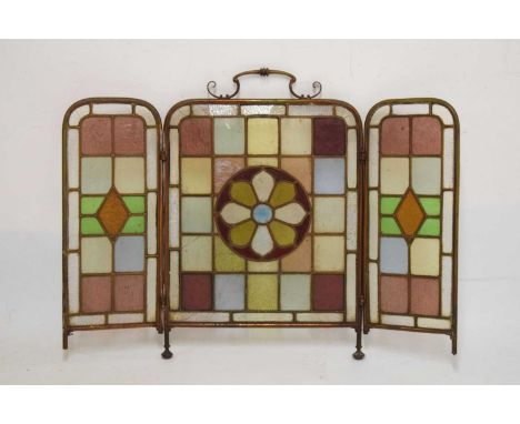 Early 20th Century stained glass and gilt metal folding triptych fire screen, 93cm wide x 70cm high (fully extended)