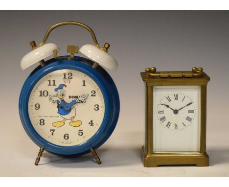 Donald Duck Walt Disney alarm clock, 18cm high, together with a brass cased carriage clock with single train movement, 10cm h