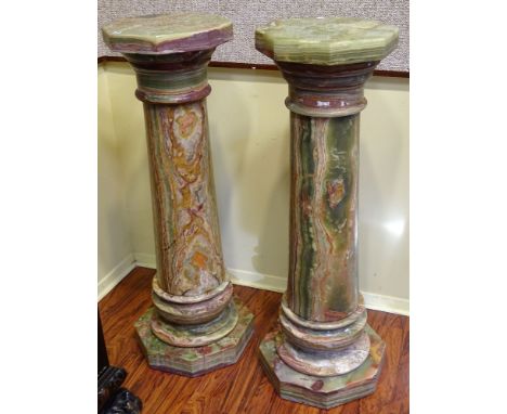 A Pair of Large Green Variegated Onyx Pedestals. Unsigned. Minor Edge Roughness or in Good Condition. Measures 43 Inches Tall