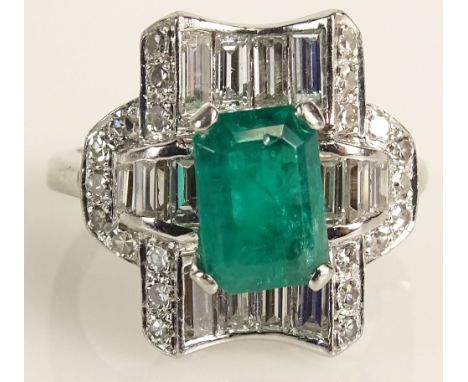 Art Deco Period Emerald, Diamond and Platinum Ring. The Center Stone 8mm by 7mm Surrounded by Baguette and Round Brilliant Di