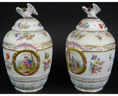 Pair of Vintage Dresden Porcelain Hand Painted Figural Covered Urns. Features Panels with Romantic Scenes, Eagle Finials and 