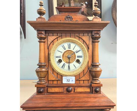 An Edwardian mantel clock with striking movement in architectural walut case (no glass door) 