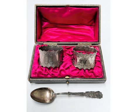 A cased pair of hallmarked silver napkin rings with incised decoration with waving borders, Sheffield 1903, a hallmarked silv
