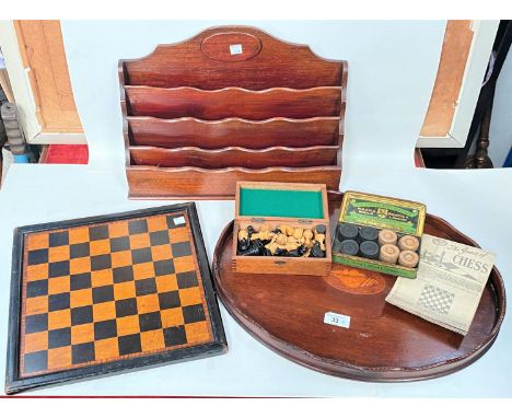 An oval inlaid mahogany tray; a mahogany letter rack, a chess and draughts set 