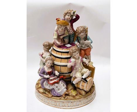 A large Meissen style group of children climbing on a wine barre, crossed sword and R marks to base, height 28cm 