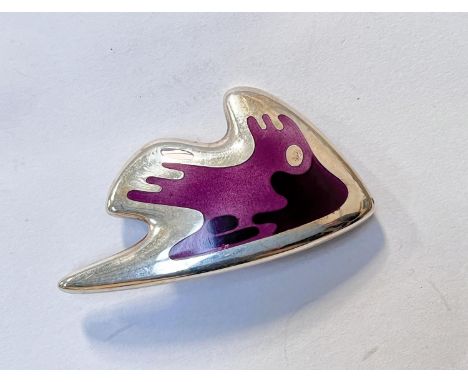 Georg Jensen:&nbsp; a modernist silver brooch in the form of a stylized fish with body in shades of purple enamel, raised ova
