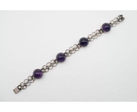 An amethyst cabochon and white-metal bracelet, the amethyst bosses rub set and suspended on a fancy link chain, stamped '925'