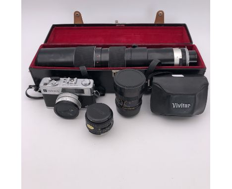 A Yashica electro 35GX camera, a Nikon Series E 1:28 F=28mm lens, and a Tamron 1:6.9 F=200 - 500mm auto zoom lens with case