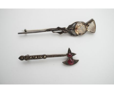 A vintage white metal (tested as silver and stamped "Sterling silver") brooch modelled as a battle axe and set with pink ston