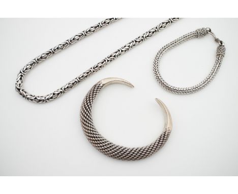 Eastern style white-metal jewellery, including a cabled torque bangle, stamped '925', a plaited link bracelet, and a fancy-li