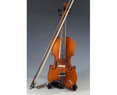 A vintage violin, having a two-piece back, the bridge stamped 'Bausch', together with two unnamed bows, in a fitted case