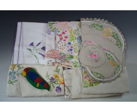 A quantity of vintage freestyle hand-embroidered table linens, including a draw-string vegetable bag and a felt purse in the 