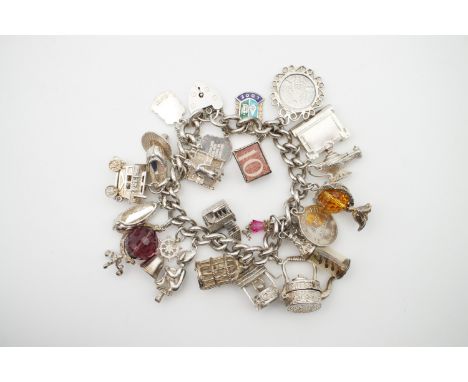 A vintage silver charm bracelet and charms, including a gypsy caravan, pixie, amethyst 'globe', citrine lion, wedding chapel,