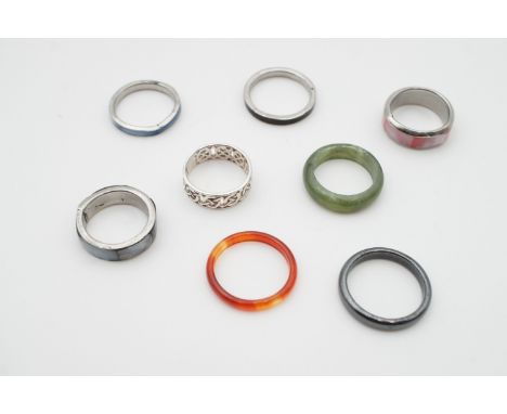 Eight white metal and hardstone rings, including a white metal Celtic strapwork band (tests as silver)