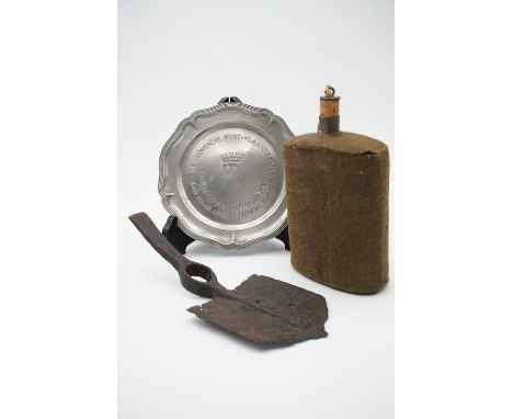 A Great War battlefield-recovered British army entrenching tool, a water bottle and pewter commemorative plate