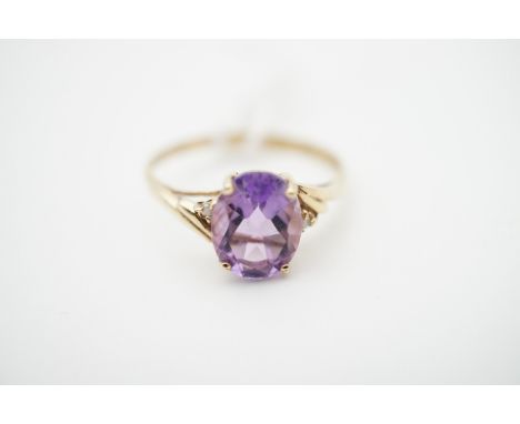 A contemporary amethyst and diamond dress ring, on a yellow-metal shank, stamped '375' (tests as gold), O, 1.3g