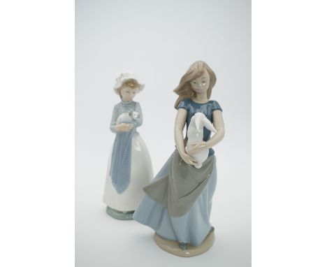 Two Nao figurines, girl with rabbit, and girl with puppy