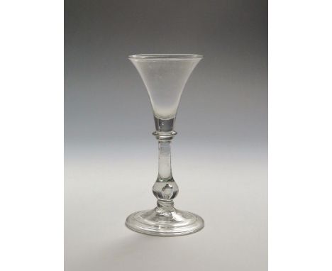 A light baluster glass  c.1730, the flared bowl above a collar on a baluster stem enclosing a tear above a basal knop and fol