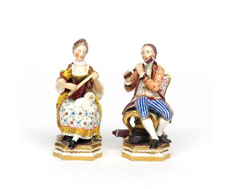 A pair of Derby figures of musicians  c.1800, seated on high-backed chairs, he playing the flute and she the lute with a smal