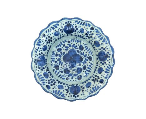 A small lobed delftware dish  late 17th century, probably London, decorated with a stylized floral design echoed to the rim, 