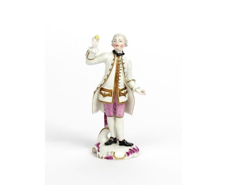 A Frankenthal figure of a gallant  c.1765, standing and holding a single lemon aloft in his right hand, raised on a low scrol
